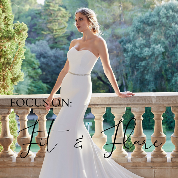 Model in Ronald Joyce style 18501, a classic plain fit and flare wedding gown with a strapless sweetheart neckline, sparkle beaded belt and sweeping integrated cathedral train.